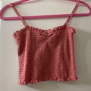 ruched pink crop top with frills lining the bottom